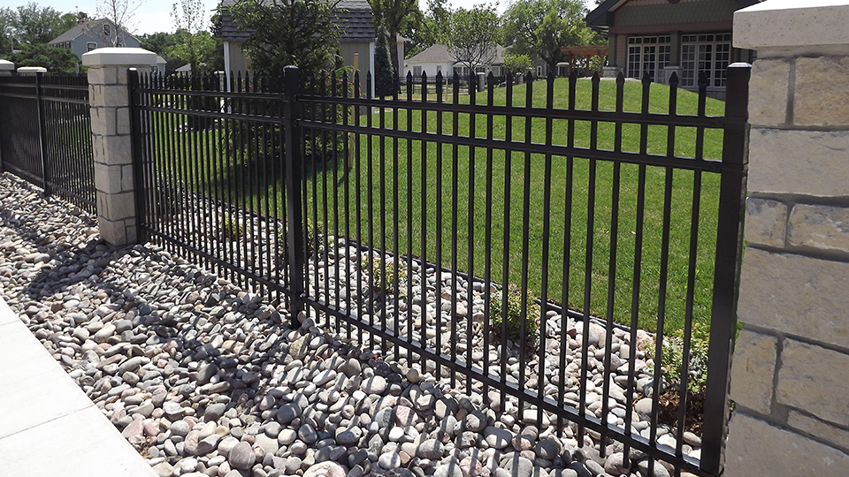 Extraordinarydesignofwroughtironfenceandunilockbrickwall