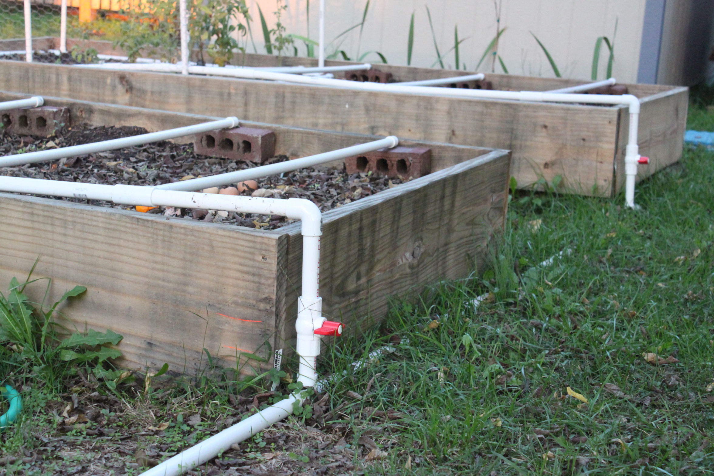 A Diy Raised Brick Planter Greenhouse